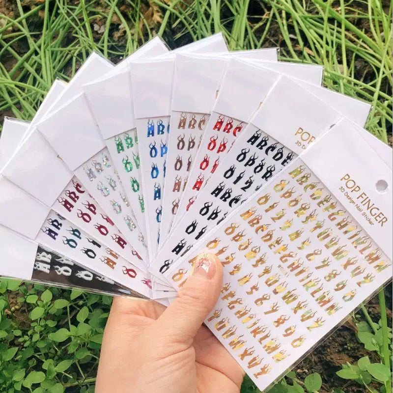 Color: Brown - 1PCS New English Alphabet Nail Stickers Multi-Color Laser Reflective Nail Slider Art Cool Text Nail Kit